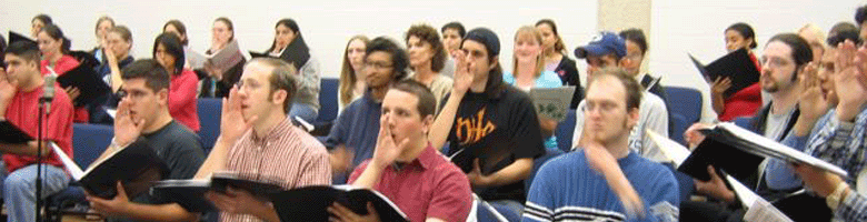 University Singers, Texas A & M University-Corpus Christi (TAMUCC), Dr. Sam Lodgsdon, Director,  taking a finger breath while preparing for a performance of Beethovens Symphony No. 9.